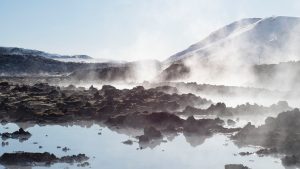 iceland hot springs white clouds over lake during daytime